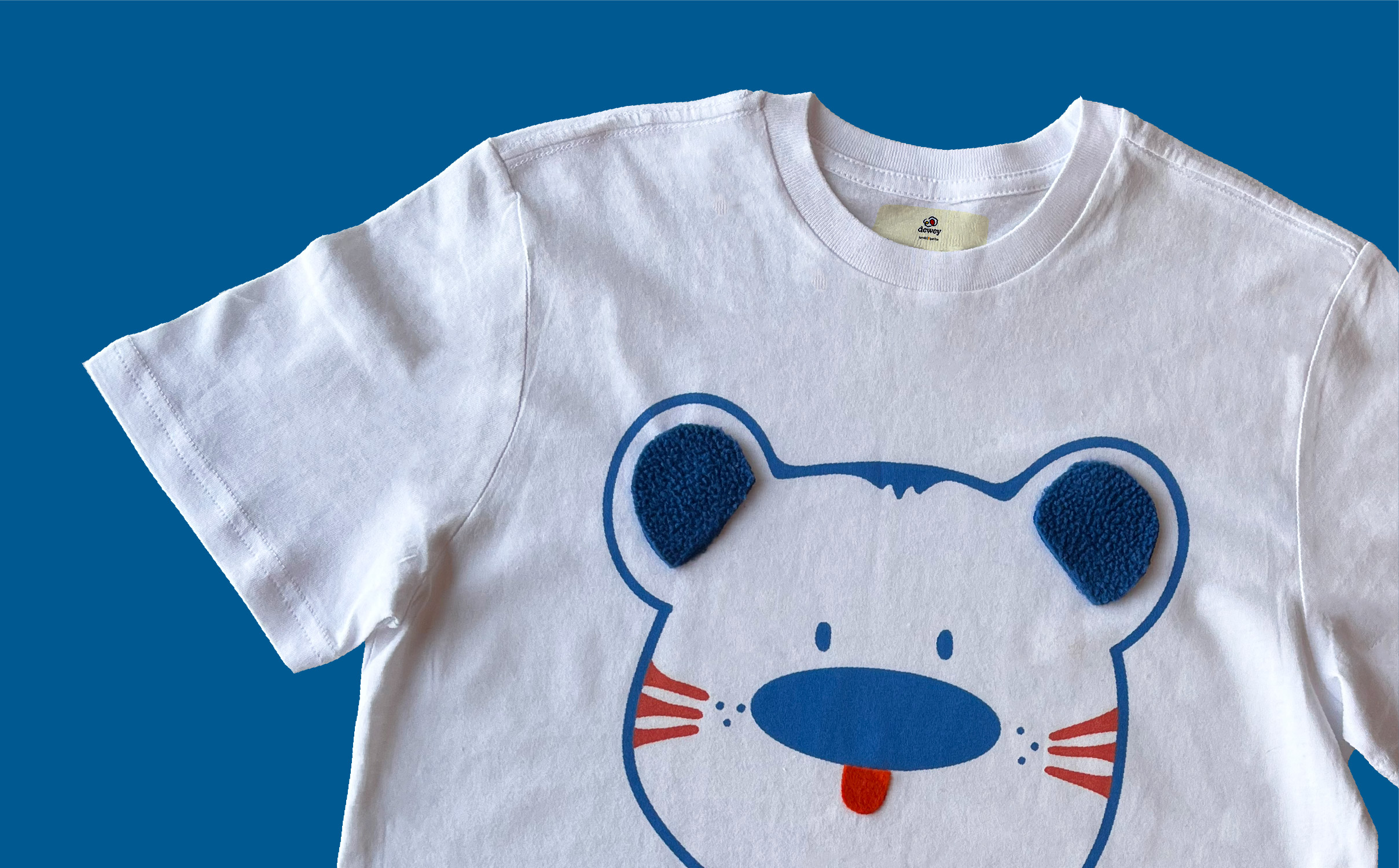 Close-up of the bear Dewey t-shirt that has fabric patches on the ears and mouth.